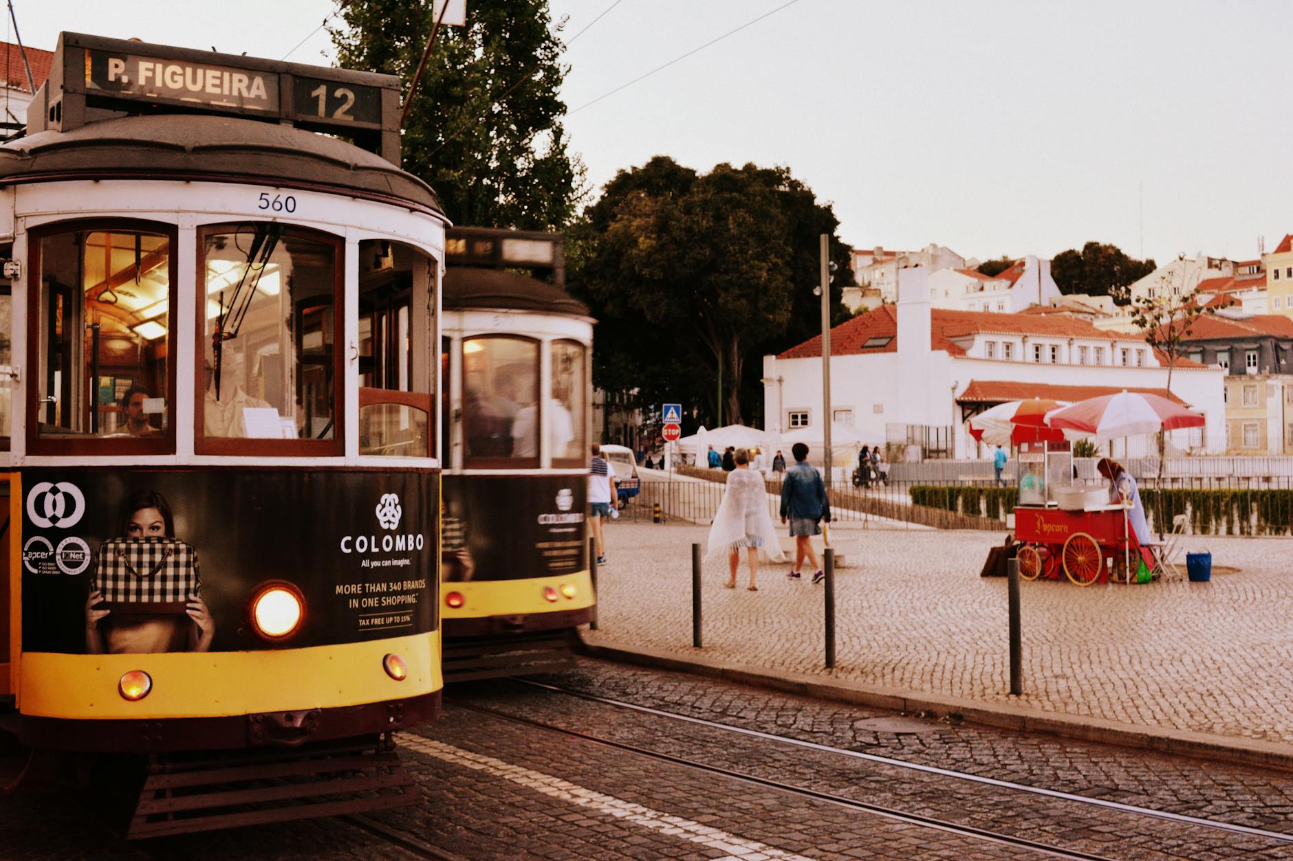 Charming view of Lisbon trams and street scene at Praça da Figueira, Portugal.