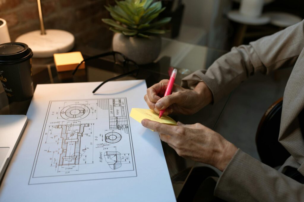 An architect's workspace featuring a blueprint, note-taking, and modern office design.