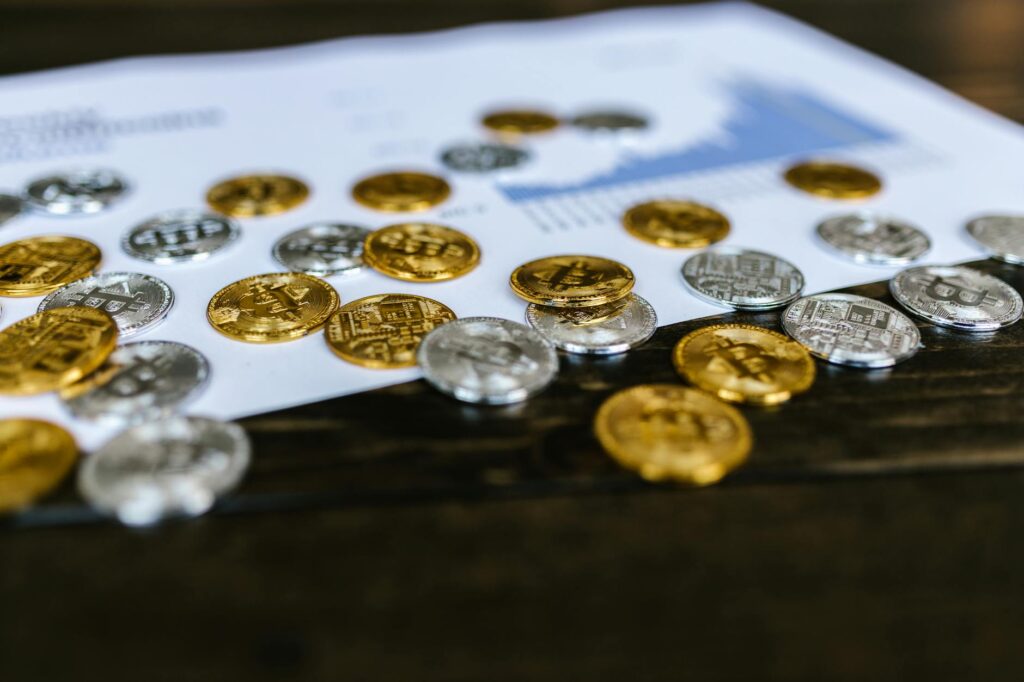 Digital currency coins on a paper chart, showcasing financial growth insights.