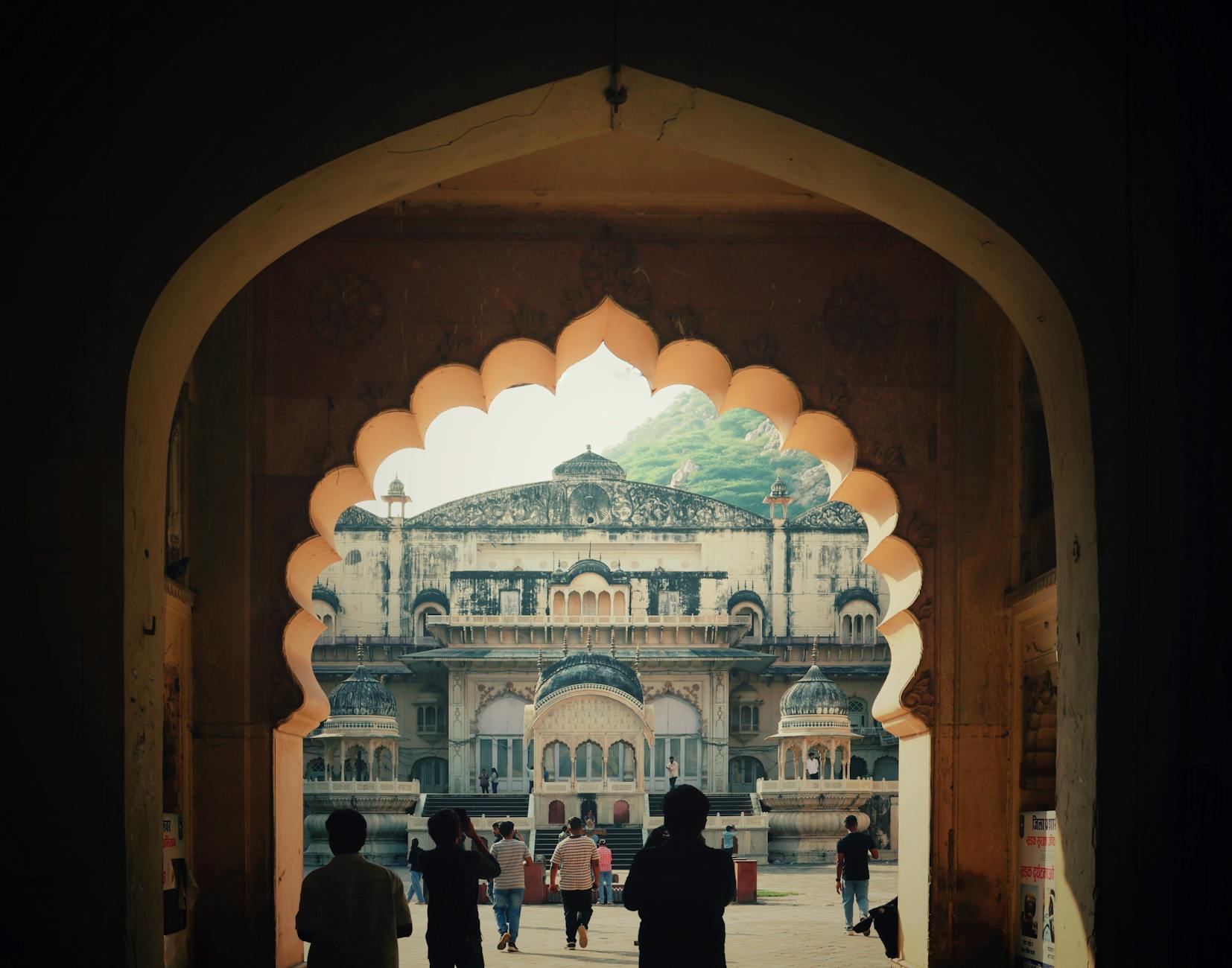 Explore the historical beauty of Alwar City Palace through an archway view.