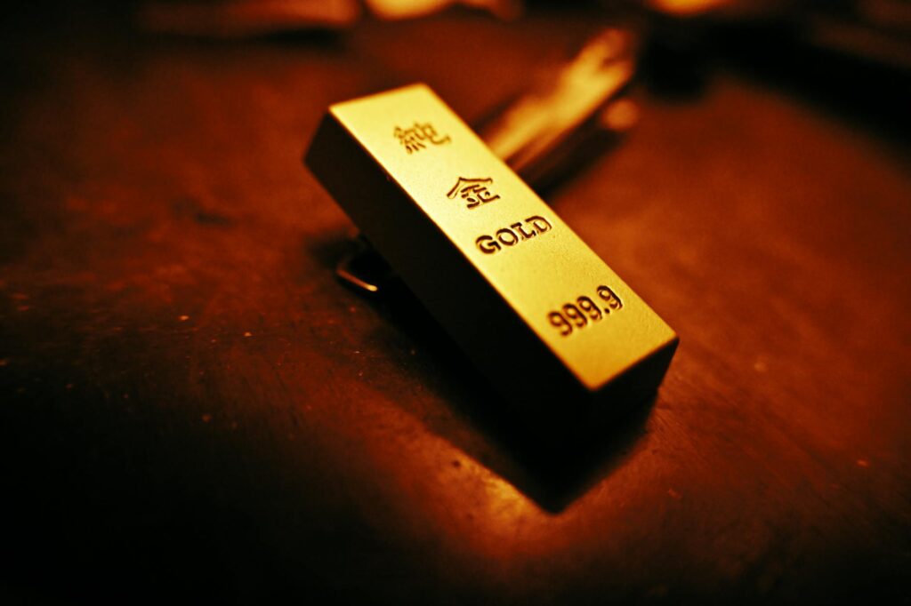 A striking close-up of a gold bar showing inscriptions, captured with warm lighting.