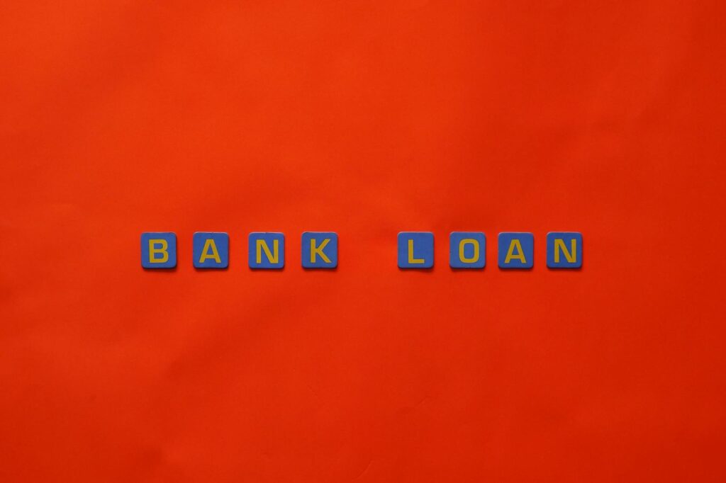 Letters forming 'Bank Loan' on a vibrant red surface, ideal for finance themes.