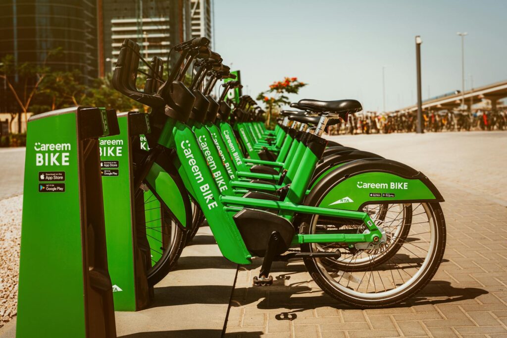 Careem bikes lined up at a downtown docking station in Dubai, ready for urban transportation.